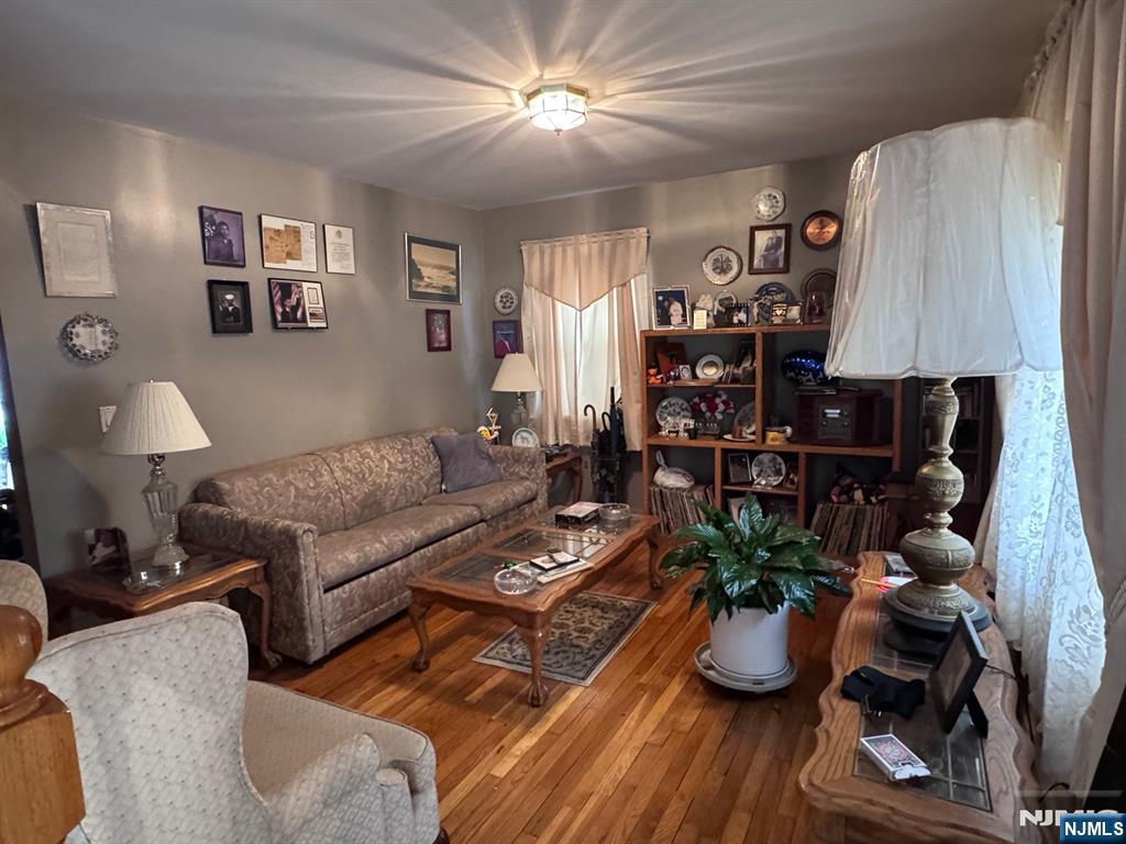 266 Hamilton Road Teaneck, NJ 07666 - Photo 2 of 27 a living room with furniture a lamp and a window