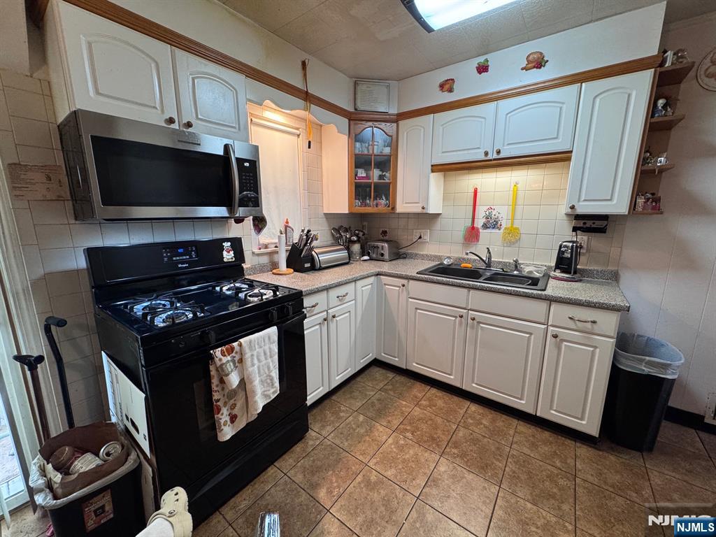 266 Hamilton Road Teaneck, NJ 07666 - Photo 7 of 27 a kitchen with a sink stove and microwave