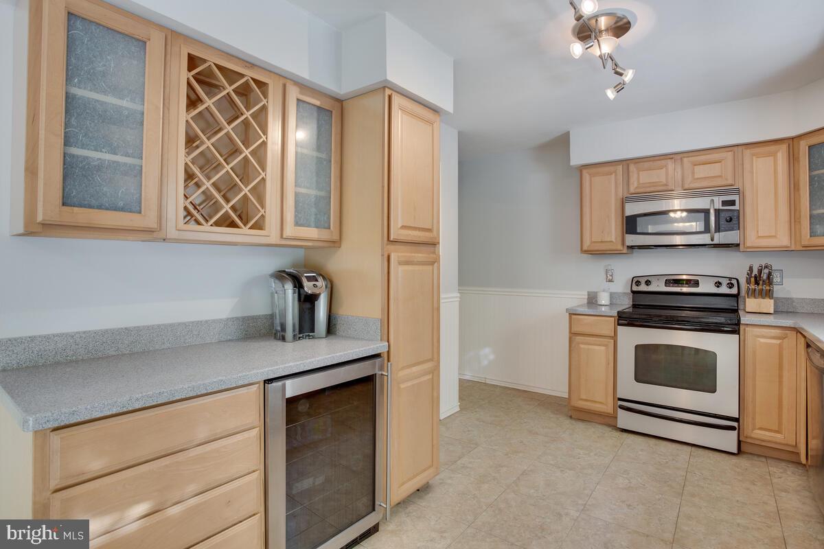 1420 Wilson Road Huntingtown, MD 20639 - Photo 7 of 43 a kitchen with stainless steel appliances a stove microwave and refrigerator