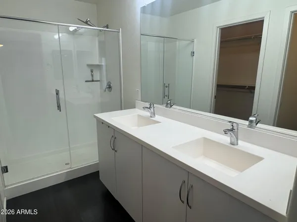 a bathroom with a sink double vanity and a mirror
