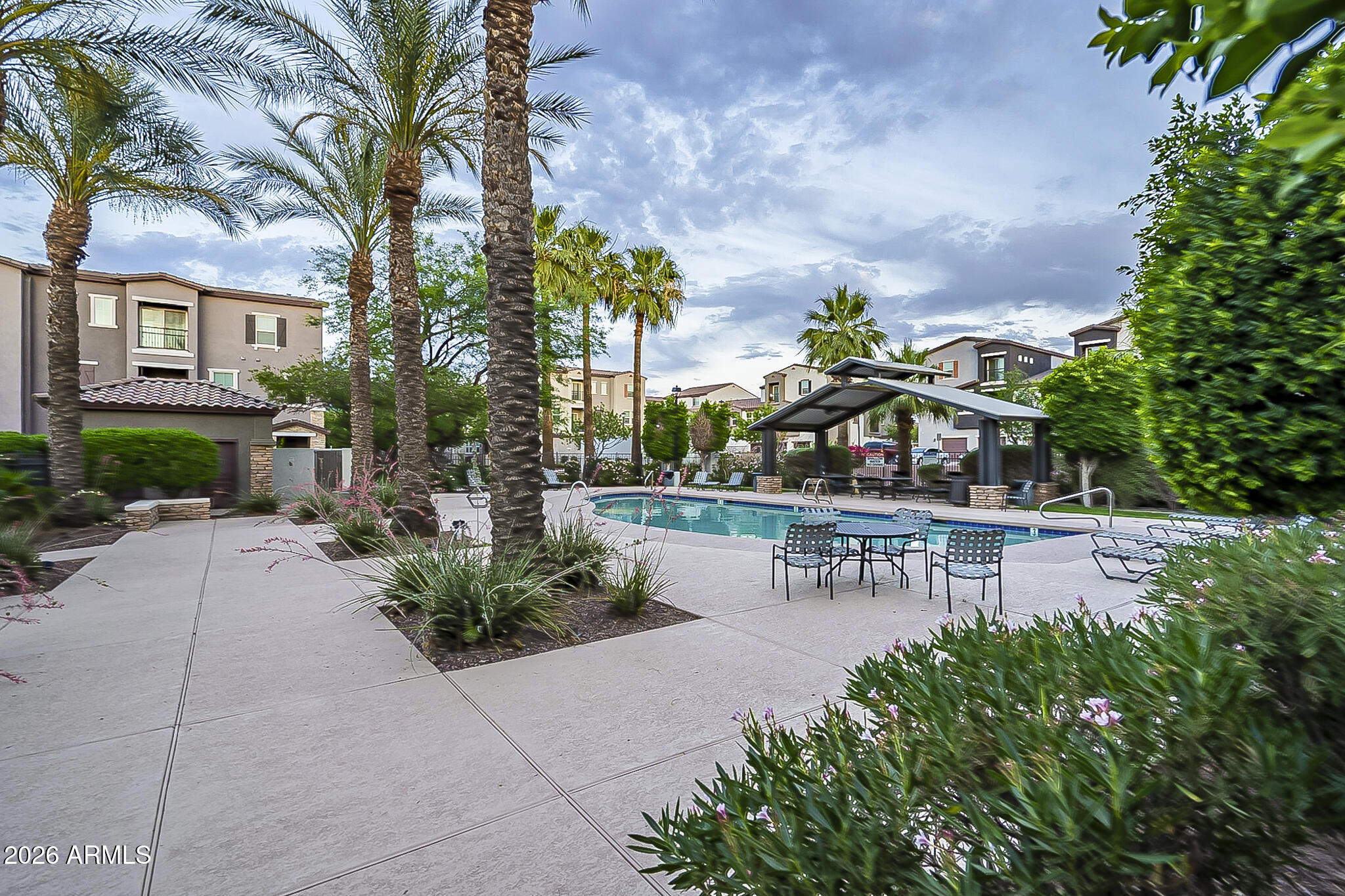5851 South 23rd Way Phoenix, AZ 85040 - Photo 16 of 24 a view of a swimming pool with sitting area and garden