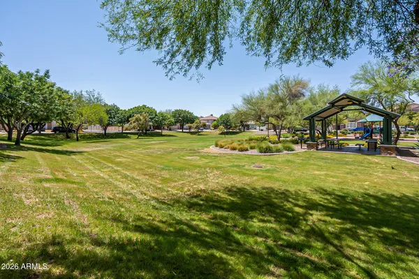 a view of yard with swimming pool and green space