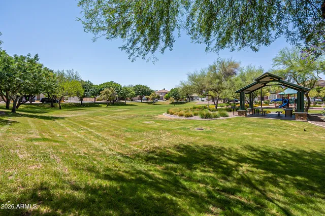 a view of yard with swimming pool and green space