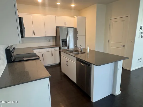 a kitchen with a sink stove and refrigerator