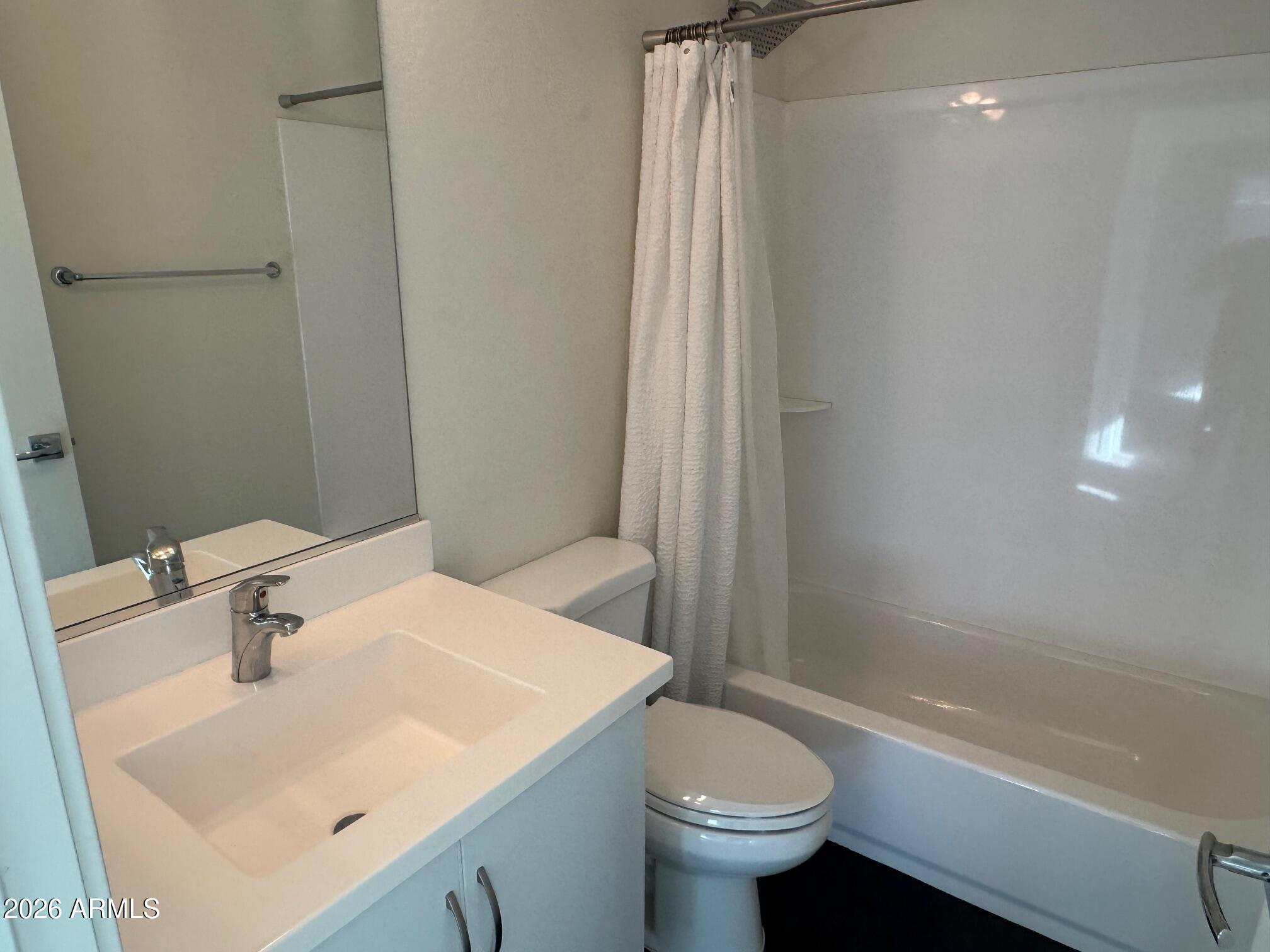 5851 South 23rd Way Phoenix, AZ 85040 - Photo 9 of 24 a bathroom with a sink a toilet and a bathtub