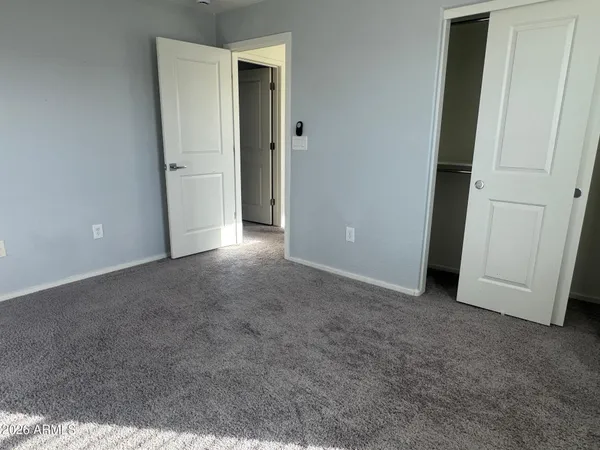 a view of an empty room and closet area