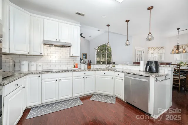 a kitchen with appliances a sink and cabinets