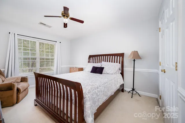 a bedroom with bed and balcony