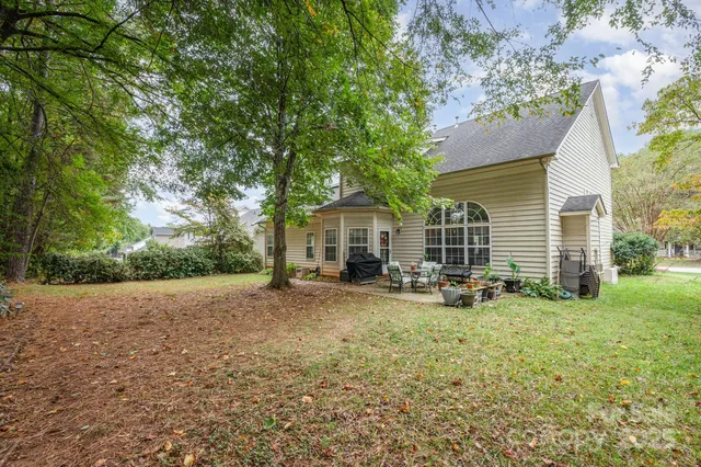 a view of a house with backyard and sitting area