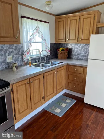 a kitchen with granite countertop a sink cabinets and window