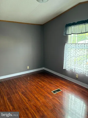 a view of room with window and wooden floor