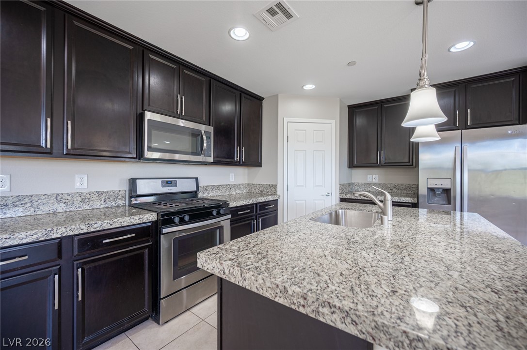 9916 Sable Point Street Las Vegas, NV 89178 - Photo 33 of 73 Well-lit kitchen with a spacious island, stainless steel appliances, and ample cabinet storage.