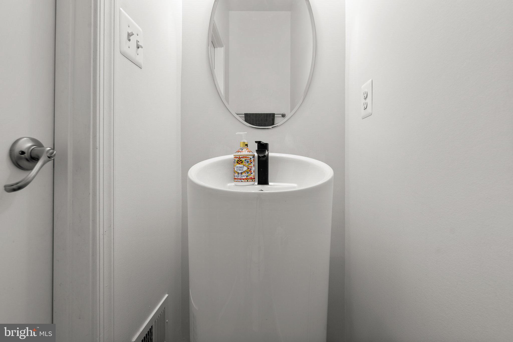 14407 Sandy Ridge Lane Laurel, MD 20707 - Photo 13 of 29 a bathroom with a sink and a mirror