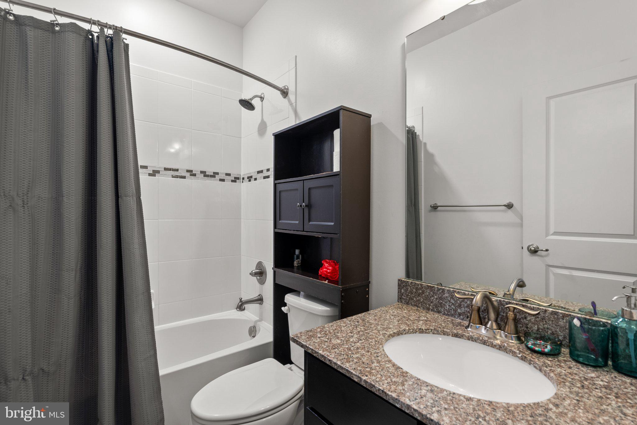 14407 Sandy Ridge Lane Laurel, MD 20707 - Photo 16 of 29 a bathroom with a granite countertop sink toilet and shower