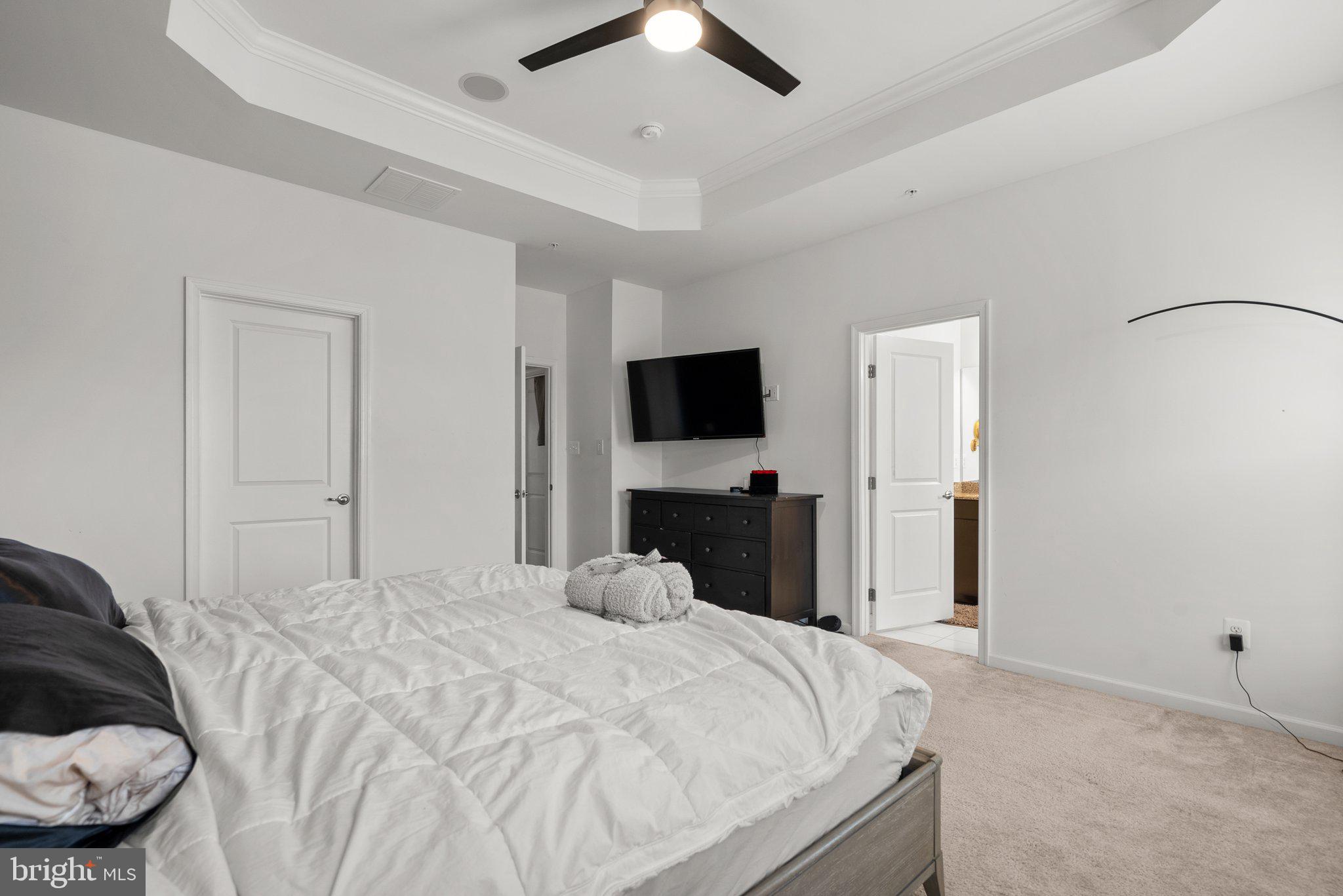 14407 Sandy Ridge Lane Laurel, MD 20707 - Photo 18 of 29 a bedroom with a bed and a flat tv screen on dresser