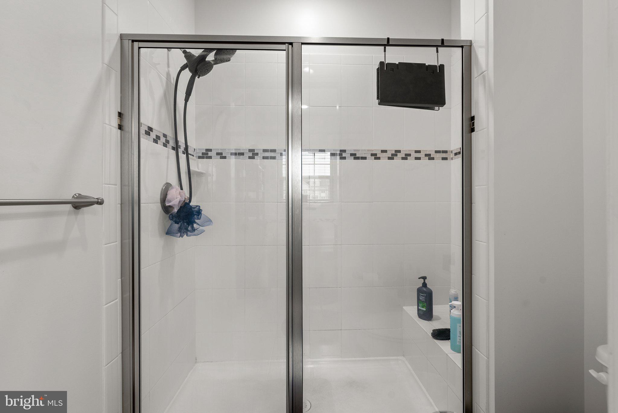 14407 Sandy Ridge Lane Laurel, MD 20707 - Photo 20 of 29 a bathroom with a shower and a bath tub