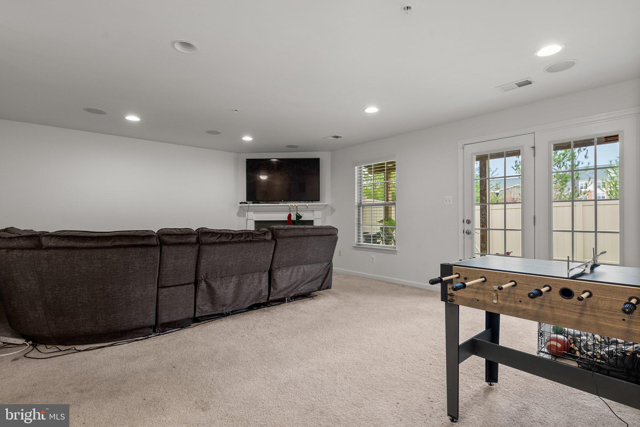 14407 Sandy Ridge Lane Laurel, MD 20707 - Photo 21 of 29 a living room with furniture a flat screen tv and a window