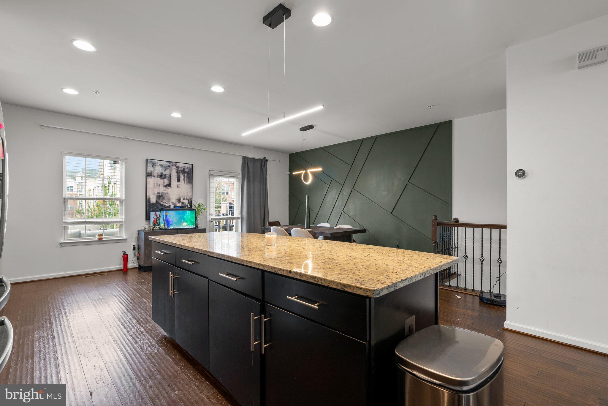 14407 Sandy Ridge Lane Laurel, MD 20707 - Photo 9 of 29 a room with a table chairs and wooden floor
