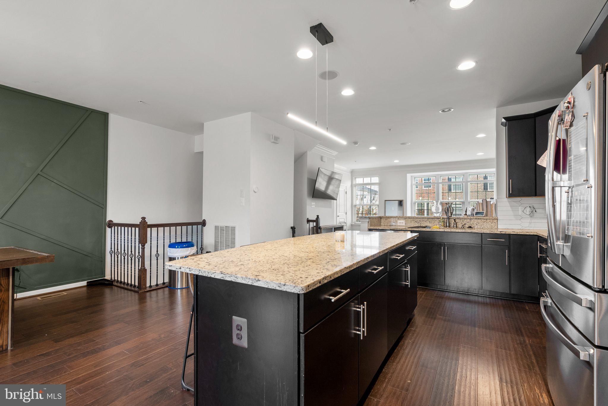 14407 Sandy Ridge Lane Laurel, MD 20707 - Photo 10 of 29 a kitchen with a sink and wooden cabinets
