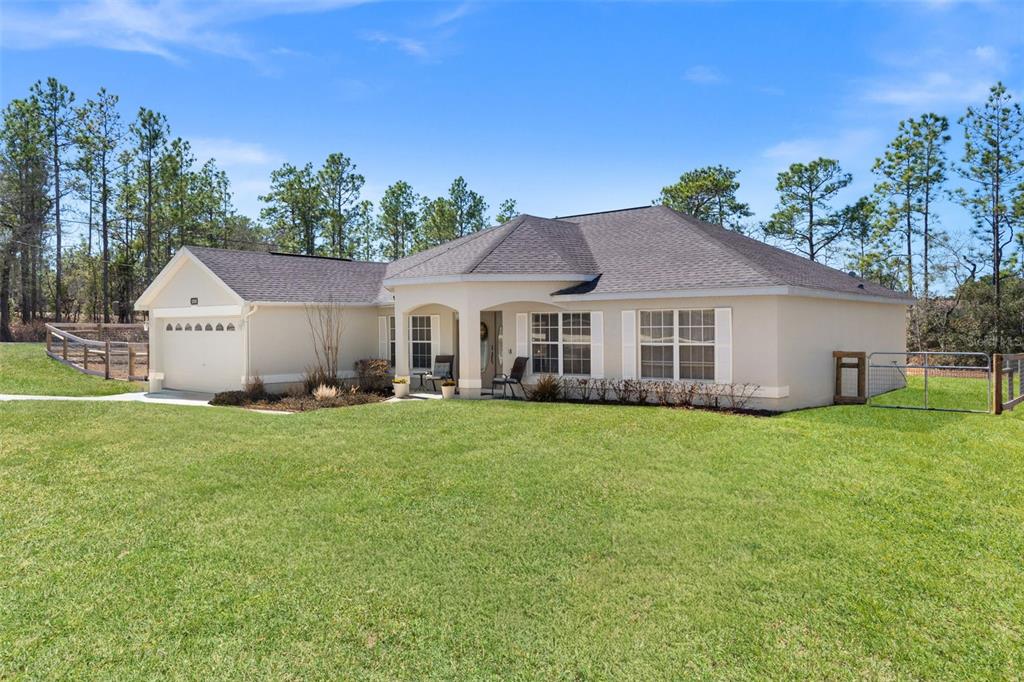 15335 Fleetwood Road Weeki Wachee, FL 34614 - Photo 2 of 40 a front view of a house with a garden
