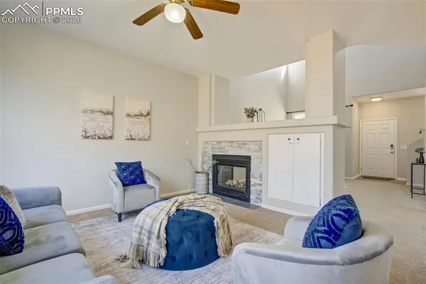 a living room with furniture and a fireplace