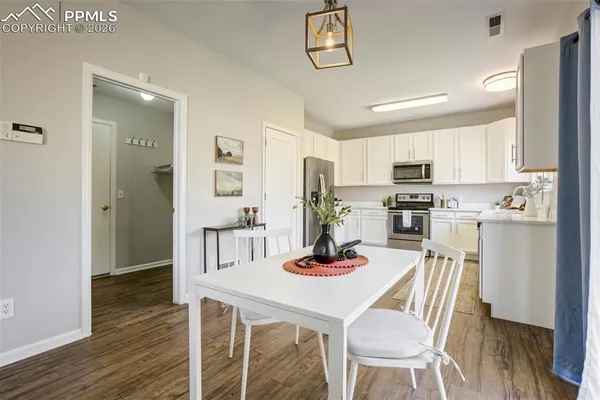 a kitchen with kitchen island white cabinets and stainless steel appliances