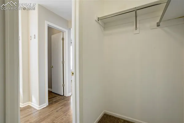 a view of a room with wooden floor