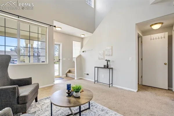 a living room with furniture and a potted plant