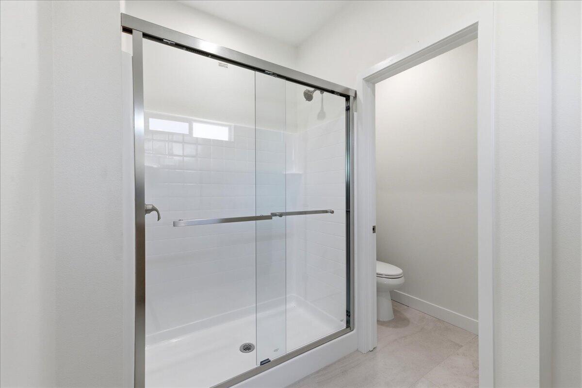 68160 Modalo Road Cathedral City, CA 92234 - Photo 18 of 57 a bathroom with a glass shower door