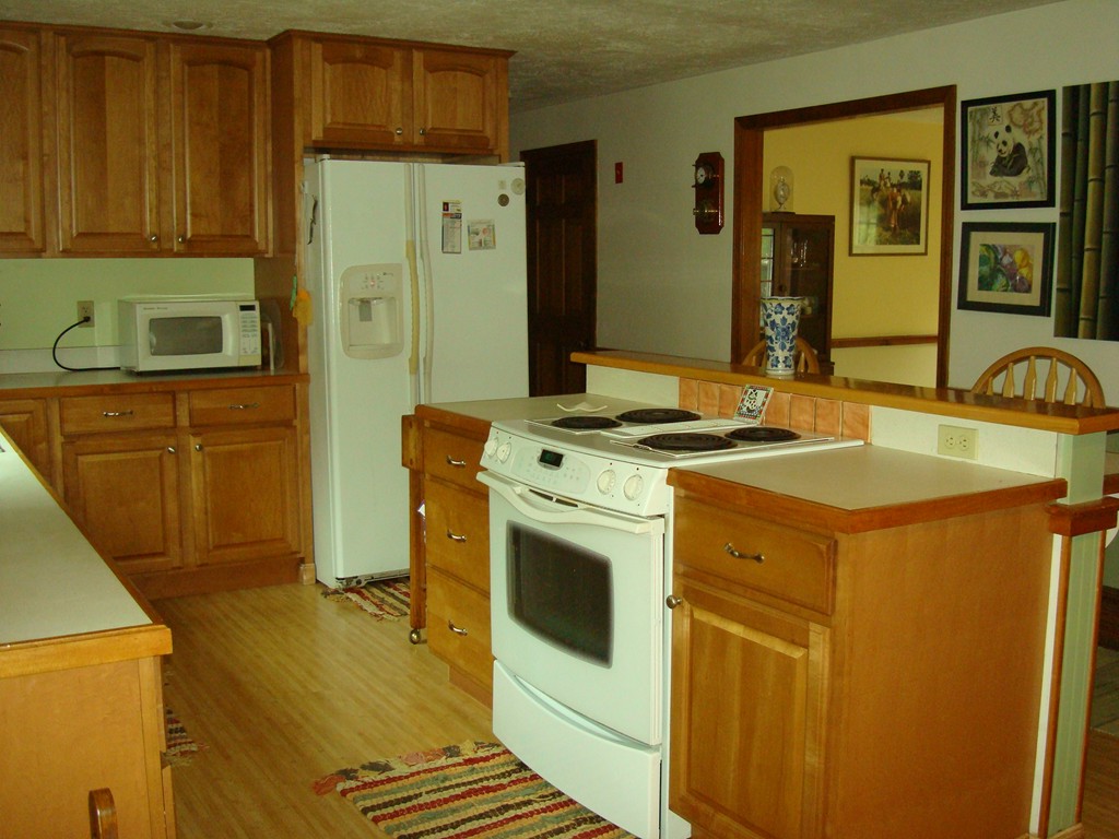 31 Stuart Road Rochester, MA 02770 - Photo 11 of 30 a kitchen with stainless steel appliances granite countertop a sink stove and refrigerator
