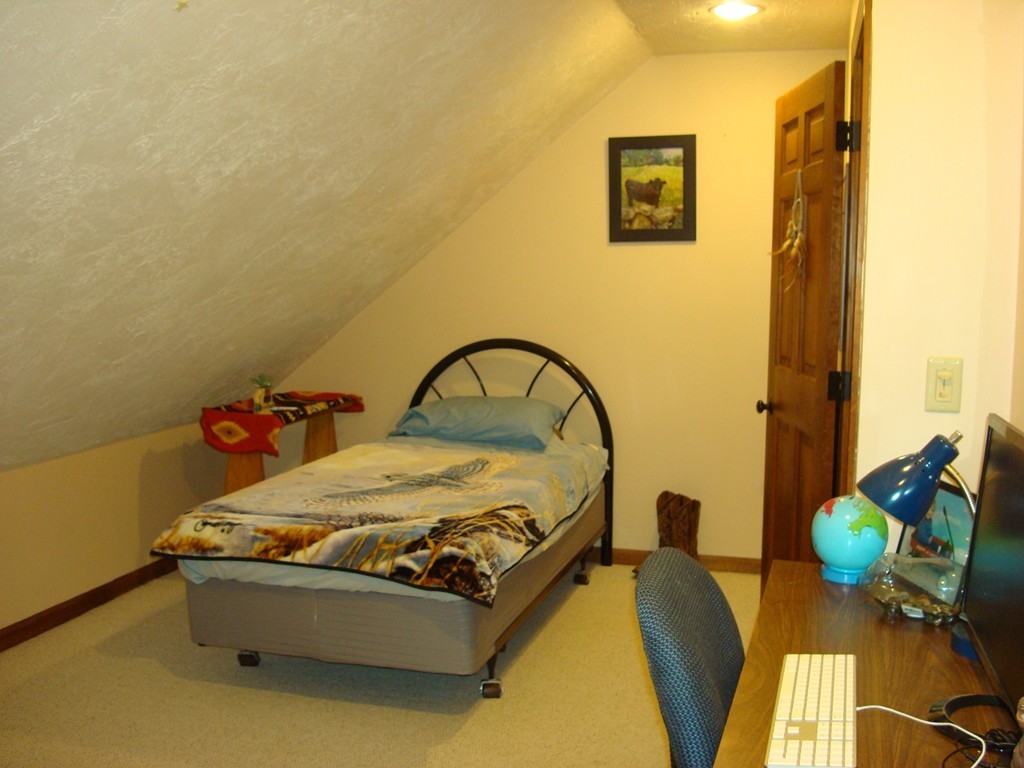 31 Stuart Road Rochester, MA 02770 - Photo 22 of 30 a bed sitting in a bedroom next to a window