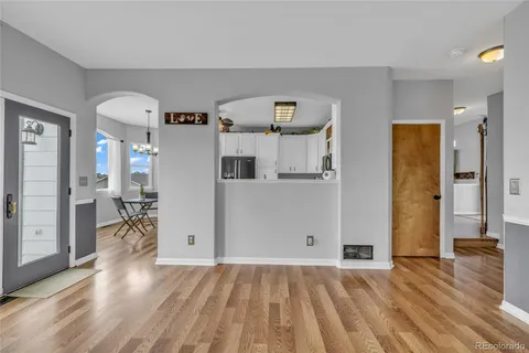 a living room with furniture and a chandelier