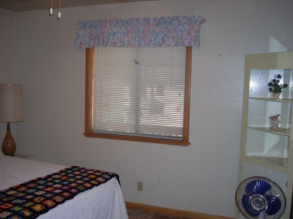 2923 Markham Road Overgaard, AZ 85933 - Photo 15 of 33 a bedroom with a bed and a window