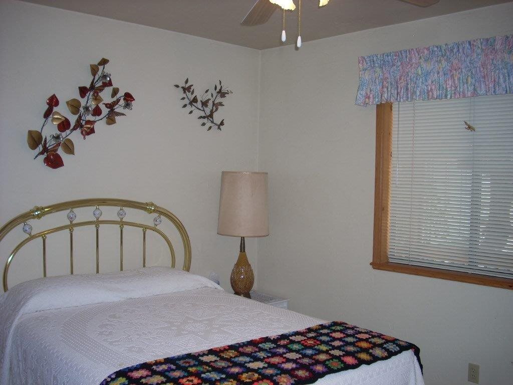 2923 Markham Road Overgaard, AZ 85933 - Photo 16 of 33 a bedroom with a bed and a window