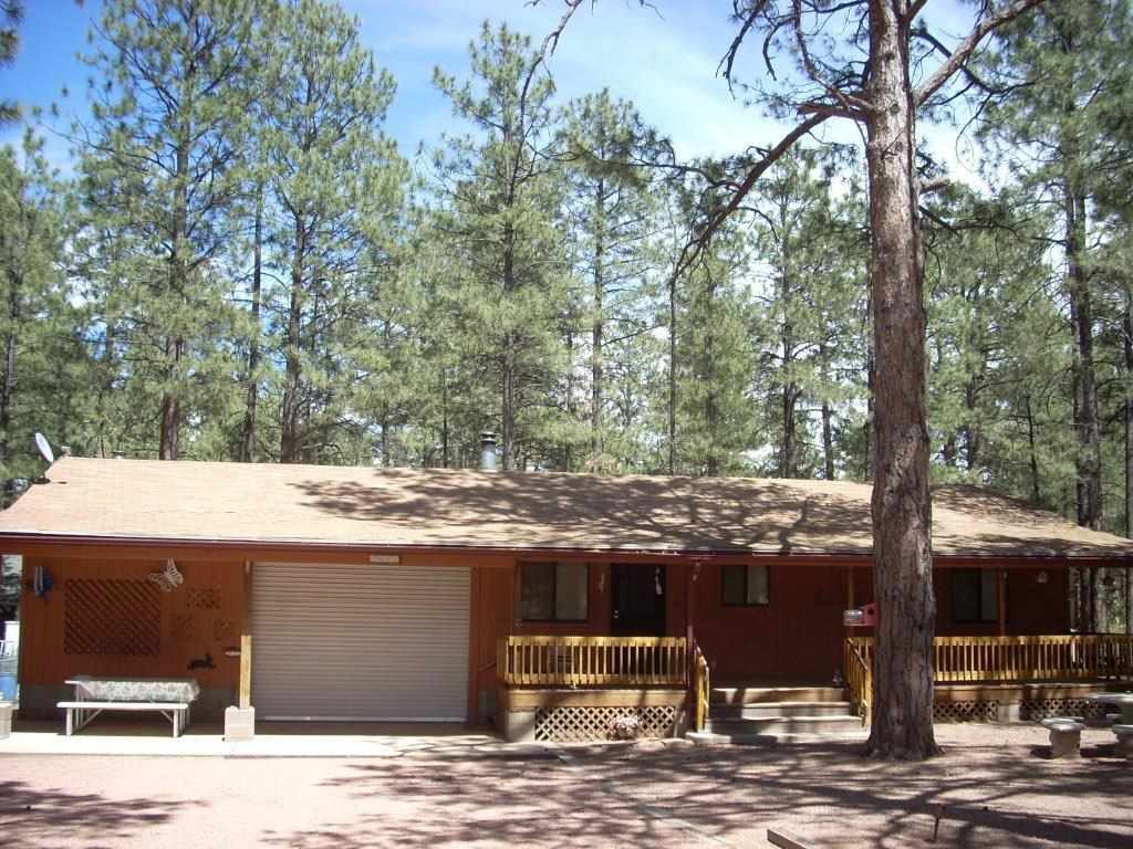 2923 Markham Road Overgaard, AZ 85933 - Photo 24 of 33 a view of a house with a yard
