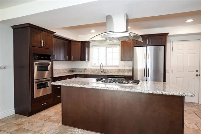 a view of a kitchen with a sink stainless steel appliances and cabinets