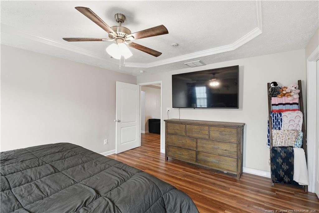 212 Lennox Loop Raeford, NC 28376 - Photo 27 of 47 a bedroom with a bed and a flat screen tv