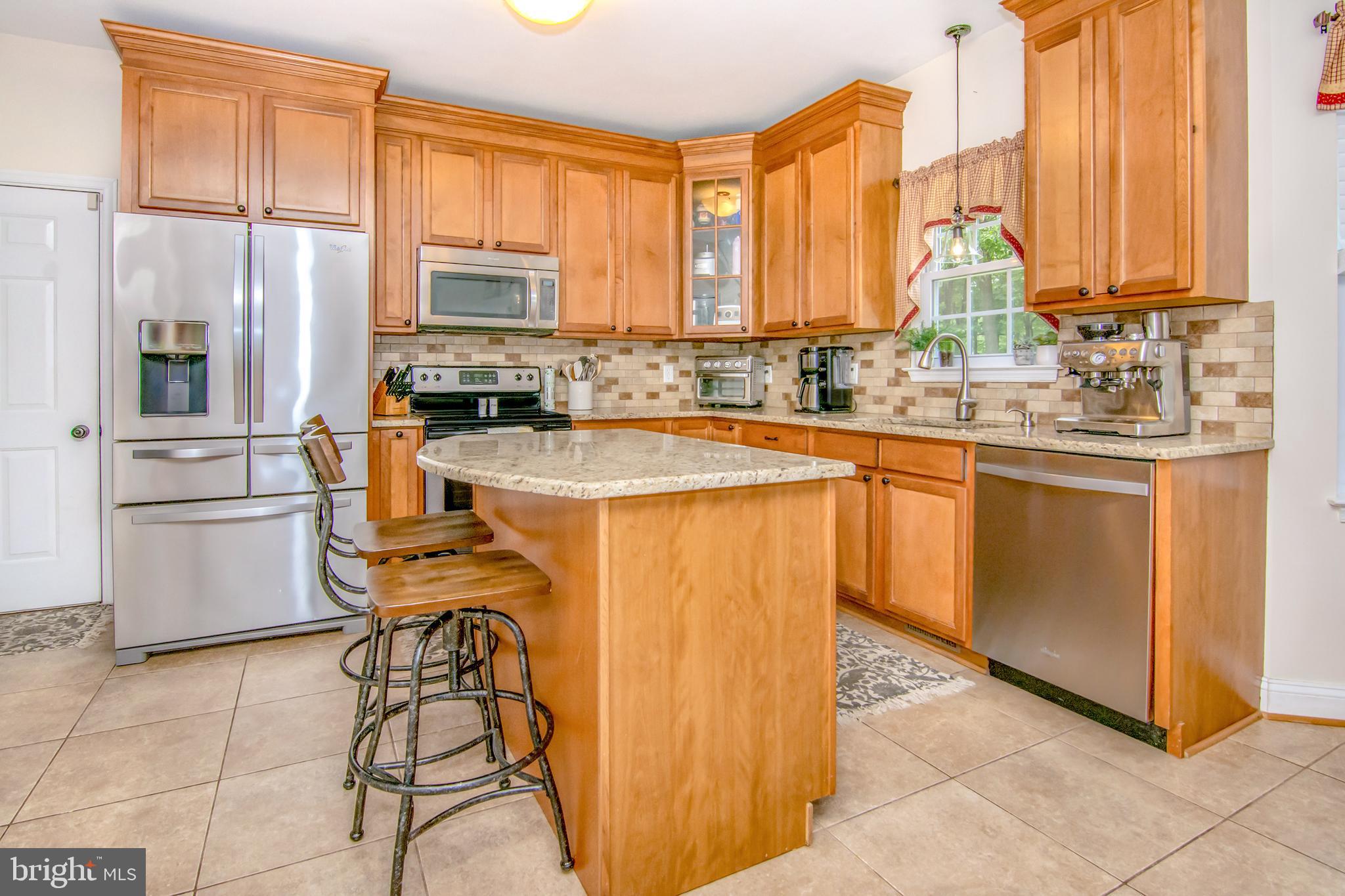 167 Aubel Road Delta, PA 17314 - Photo 9 of 27 Granite Counters, Tile Backsplash and Stainless