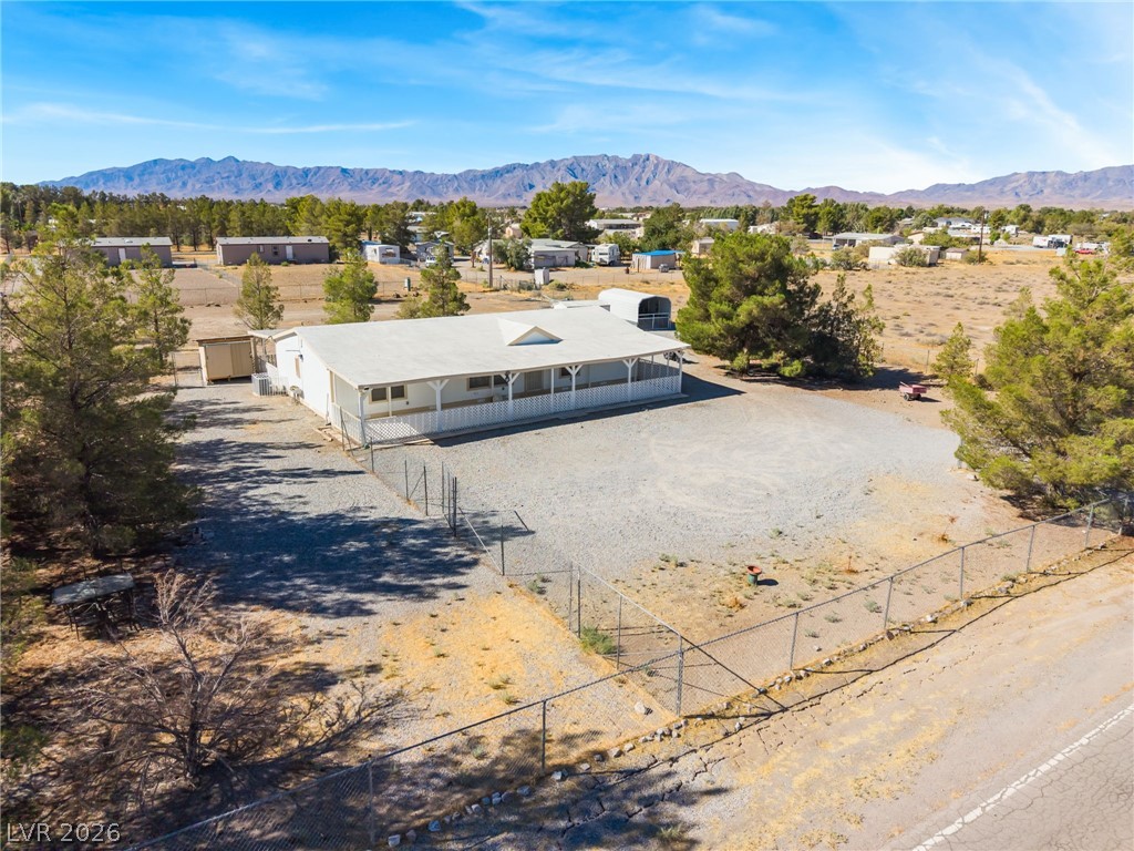 1551 West Wilson Road Pahrump, NV 89048 - Photo 48 of 68 Majestic mountain ridges frame this expansive property featuring a fenced yard and covered front porch.