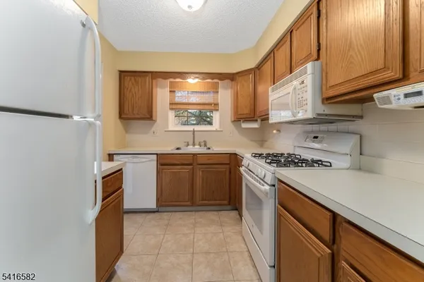 a kitchen with a sink stove and refrigerator
