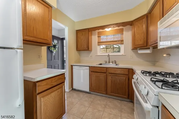 a kitchen with a sink cabinets and appliances