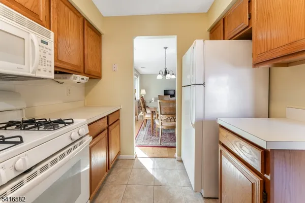 a kitchen with stainless steel appliances granite countertop a refrigerator and a stove