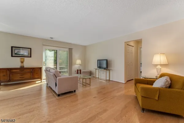 a living room with furniture and a lamp