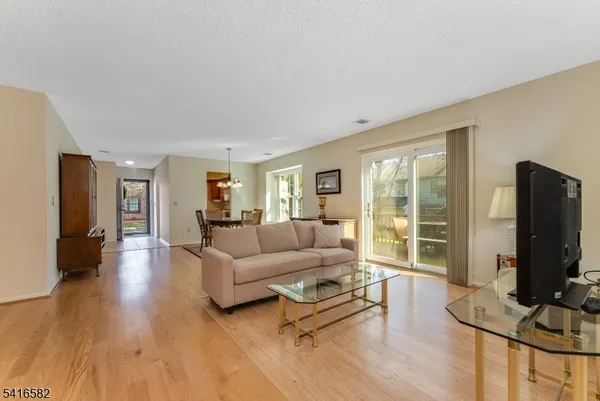 a living room with furniture flat screen tv and a large window