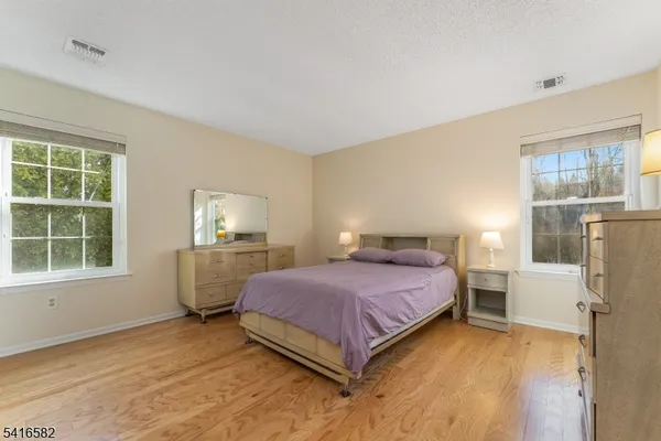 a bedroom with a bed and windows