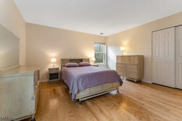 a bedroom with a bed and cabinets