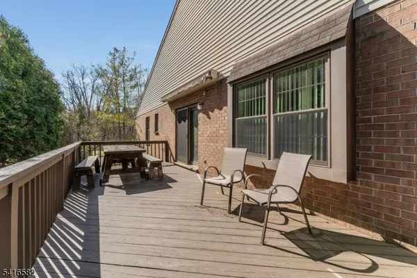 a balcony with wooden floor and furniture