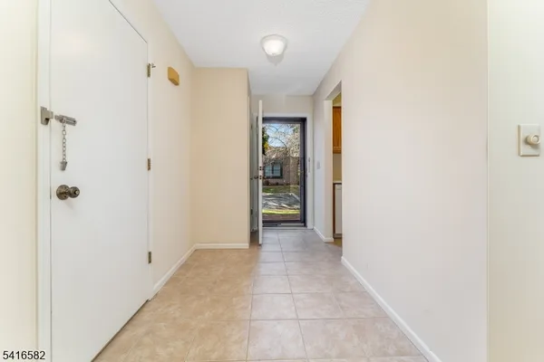 a view of a hallway with wooden shelves