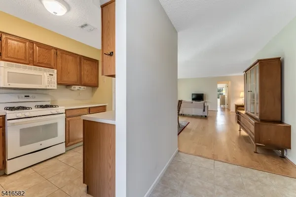 a kitchen with stainless steel appliances a stove top oven a sink a refrigerator and cabinets