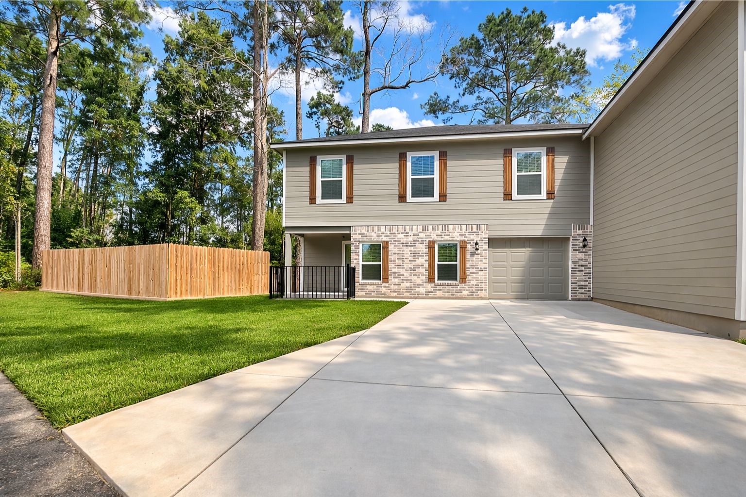 1100 Mann Road Conroe, TX 77303 - Photo 1 of 16 a view of a house with a backyard